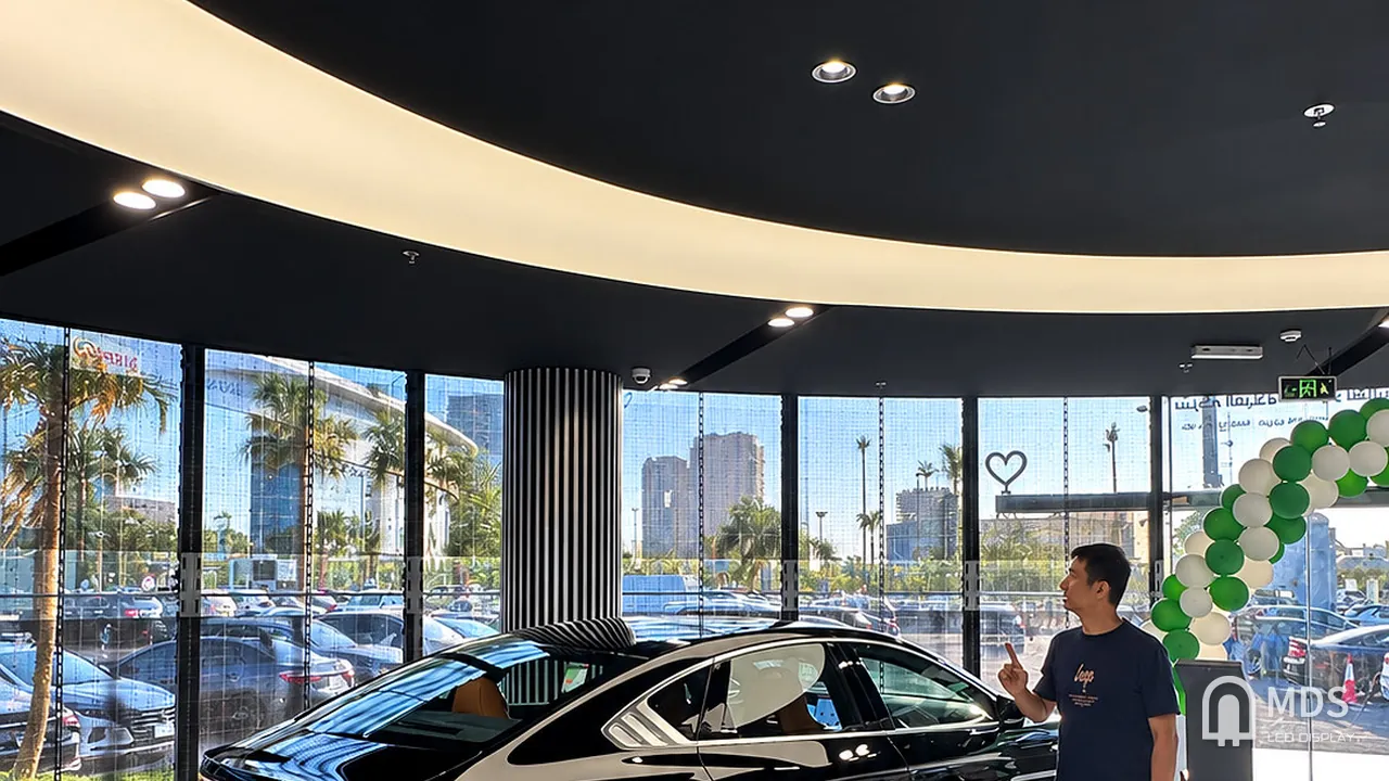 Inside the BYD showroom in Jeddah: a display car in front of the glass facade fitted with the MDS transparent LED display