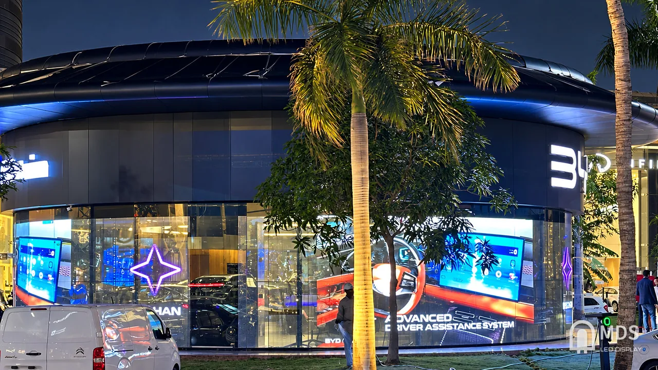 Wide night view of the 360-degree MDS transparent LED facade at the BYD showroom in Jeddah, Saudi Arabia