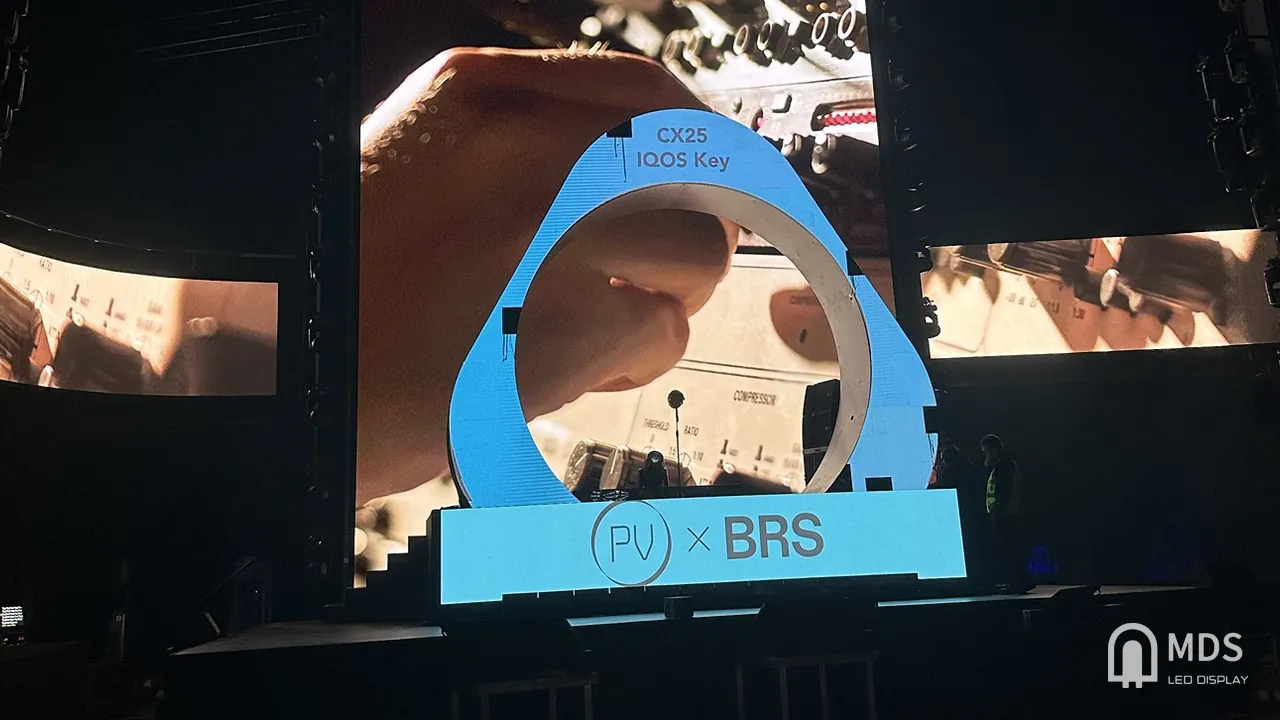 IQOS event stage: curved LED ring showing IQOS Key branding in front of the main LED screen