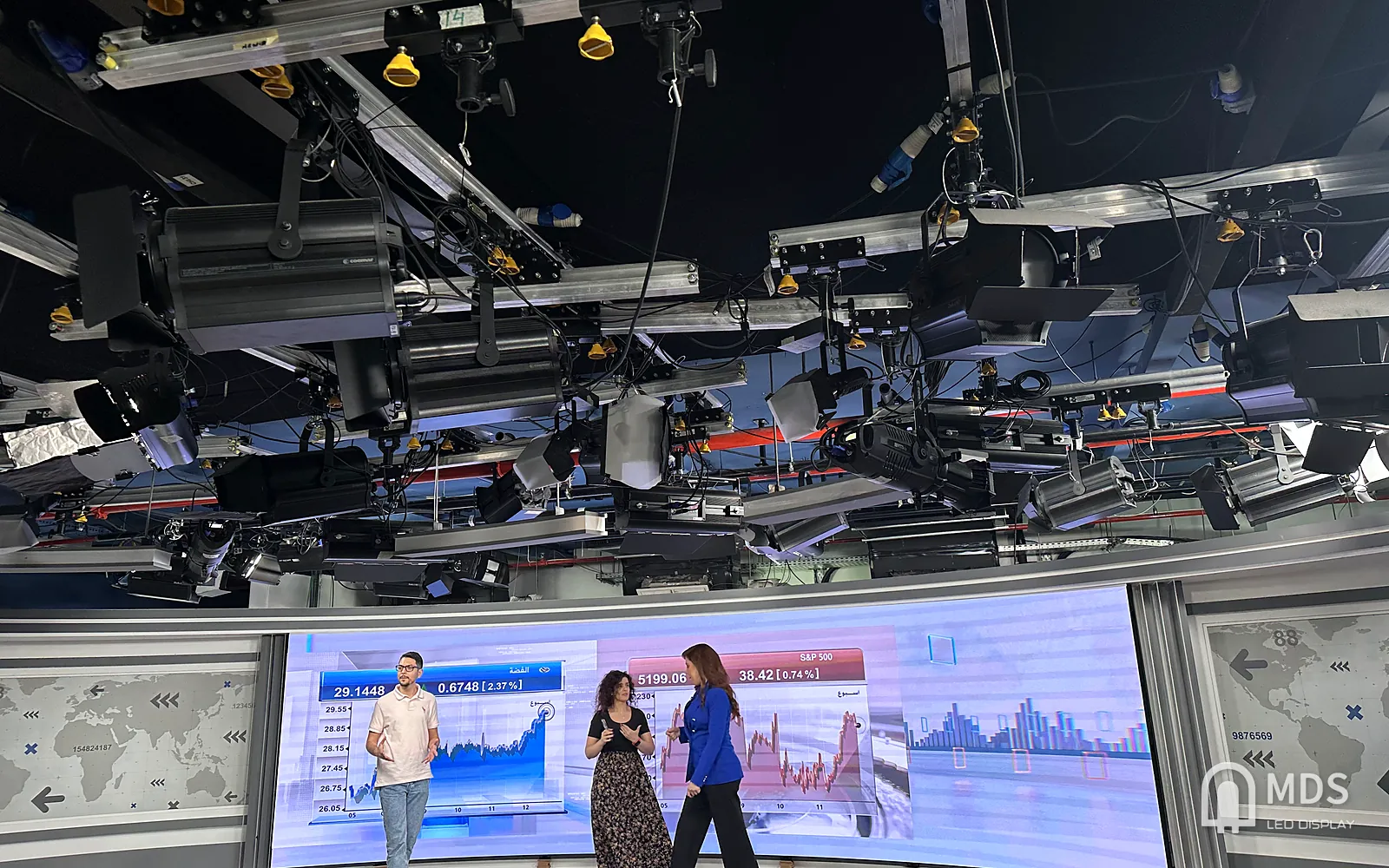 CNBC Arabia studio on air: curved fine-pitch MDS LED wall behind three presenters